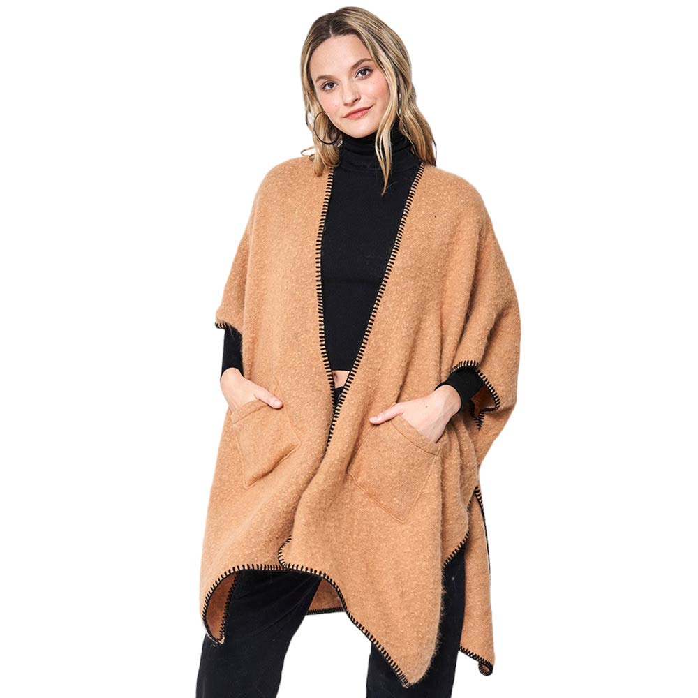 Camel Blanket Stitch Front Pockets Kimono Poncho, is designed with a stylish blanket stitch detail and two front pockets for added convenience. The poncho is made from soft, breathable fabric and is perfect for everyday wear this winter. Ideal gift for friends and family on chilly winter days. 