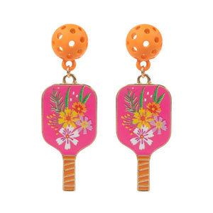 Pink Enamel Flower Pickle Ball Paddle Dangle Earrings. Step up your style game with these. These earrings feature intricately designed enamel flowers paired with pickleball paddles, making them the perfect accessory for any fashion-forward individual. Elevate your look with these exclusive and elegant earrings.