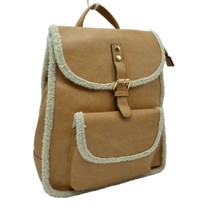 Tan Faux Shearling Trimmed Vegan Leather Foldover Backpack. This stylish bag features an elegant faux shearling trim and a back pocket for extra versatility. The faux shearling trim provides a pleasant and luxurious feel to the bag. It is perfect for carrying your daily essentials, from books to work essentials.