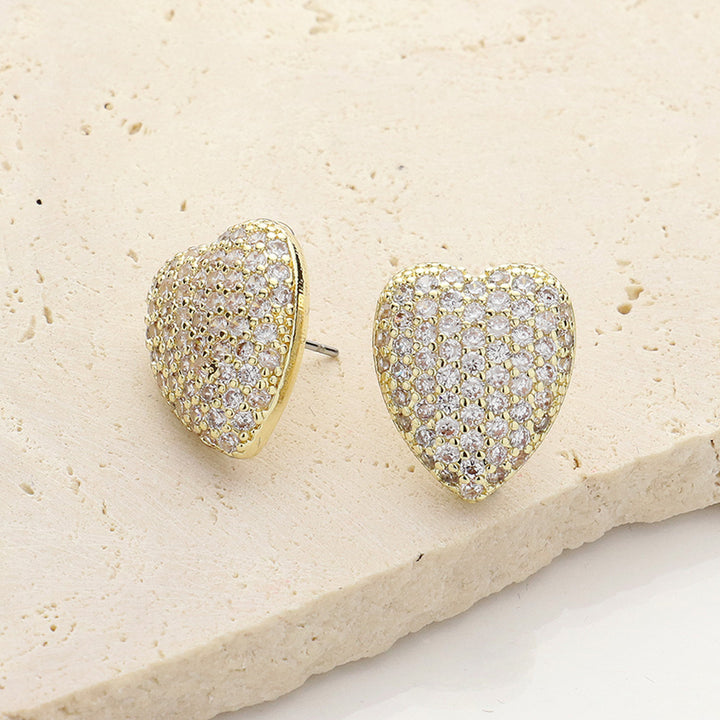 14K Gold Plated CZ Stone Paved Heart Stud Earrings add a touch of elegance to any outfit. With their stunning design and quality materials, these earrings are the perfect accessory for any occasion. The heart-shaped studs are adorned with sparkling CZ stones, making them a beautiful and eye-catching piece of jewelry. Upgrade your style with these 14K Gold Plated earrings.