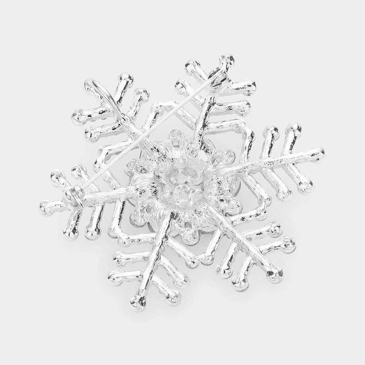 Elegant snowflake brooch pin adorned with sparkling rhinestones, perfect for adding a festive touch to winter outfits, coats, scarves, or hats. Ideal accessory for holiday parties, weddings, or as a thoughtful seasonal gift. A stylish way to showcase charm and elegance during the winter season.