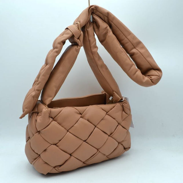 Almnd This unique handbag features a distinctive woven main compartment crafted with a thick, intertwined design for a modern, textured aesthetic. Perfect for everyday use, the bag is equipped with a generous open-top storage compartment to easily accommodate your daily essentials. A wide, matching puffy shoulder strap features a stylish knot detail near the base, ensuring comfortable carrying while adding a contemporary look to your outfit.