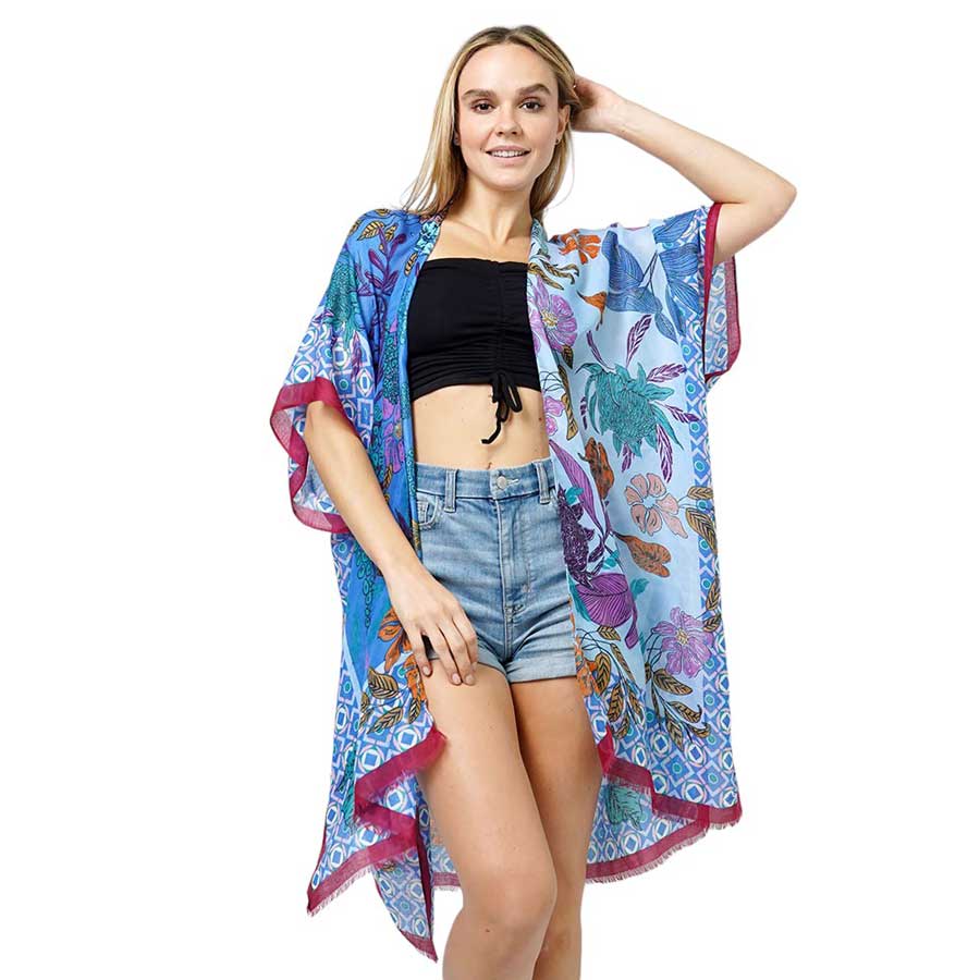 Blue Floral Print Kimono Poncho. Introducing our contemporary poncho, made from high-quality materials, this poncho features a stunning floral print that adds a touch of elegance to any outfit. With its versatile design, it can be worn as a kimono or a poncho, perfect for any occasion. Stay trendy and comfortable.