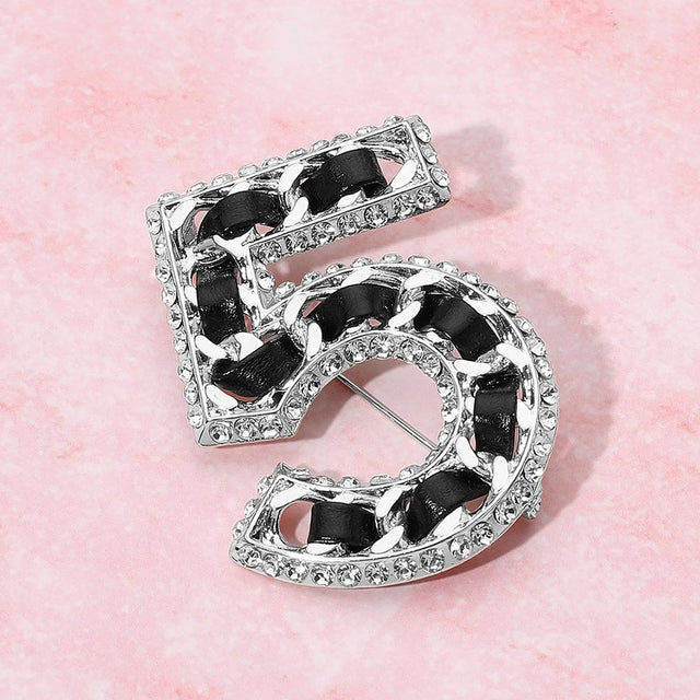Madeline Love Black, Rhodium Rhinestone Rim Faux Leather Threaded Number Five Pin Brooch - Brooches