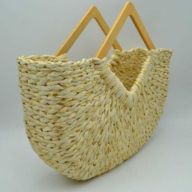 Beige This unique everyday tote bag features a thick woven basket design accented with interwoven shimmering metallic threads throughout the body. Crafted with a distinct curved silhouette that dips at the center, it opens to a spacious main storage compartment perfect for daily essentials.