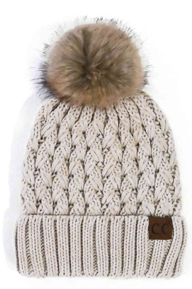Beige Elevate your winter wardrobe with the C.C Lattice Crossover Stitch Beanie, featuring an intricate lattice pattern and cozy pom detail. Crafted from 100% soft acrylic, this beanie delivers warmth and comfort without the weight. The crossover stitch design adds visual interest while the relaxed fit suits most face shapes. Perfect for layering over your favorite winter looks, this versatile beanie transitions effortlessly from casual outings to outdoor adventures. One size fits most for easy, everyday we