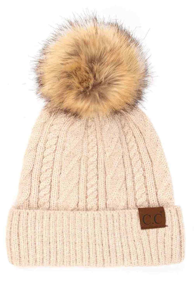 Beige The C.C Soft Cuff Beanie in Mixed Cable Pattern with Faux Fur Pom features a stylish blend of cable-knit textures topped with a plush faux fur pom for a chic winter look. Made from soft, stretchy fabric with a cozy cuff, it provides warmth, comfort, and a snug fit for cold-weather wear.