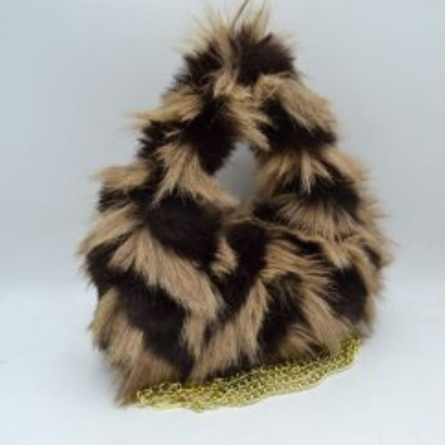 Beige This distinctive everyday handbag showcases a statement-making, long-pile shaggy plush exterior that adds unique dimension and tactile texture to your accessory collection. Designed with a soft, rounded triangular silhouette, it features a built-in top cutout handle for convenient hand carrying, alongside a separate metallic chain strap for versatile alternative styling. The central top opening provides straightforward access to the main storage compartment
