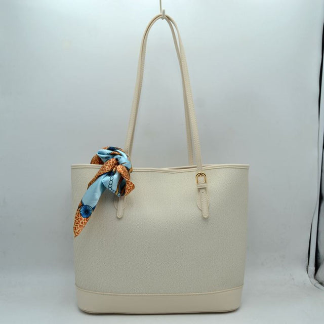 Beige Step out in style with this sophisticated and timeless tote bag. Designed with an understated chevron-style textured weave, this bag seamlessly blends classic elegance with everyday functionality. Perfect for work, travel, or upscale weekend outings, it comes complete with a vibrant, playful silk-style scarf wrapped around the handle for an instant touch of Parisian chic.