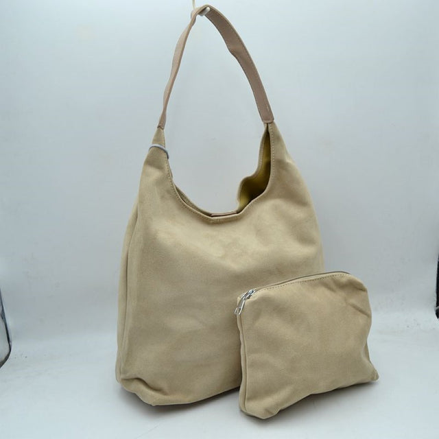 Beige This slouchy hobo bag features a clean, soft-textured exterior and a relaxed silhouette that makes it an excellent choice for everyday use. Designed with a wide, flat shoulder strap for comfortable carrying, the bag offers a spacious main compartment to easily organize and store larger essentials. Accompanied by a separate, matching inner pouch featuring a secure metallic zipper closure, this versatile set ensures smaller items stay safely tucked away.