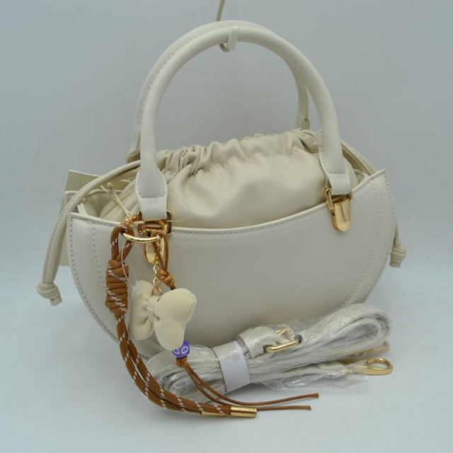 Beige This everyday handbag showcases a structured crescent silhouette with a distinctive curved profile. Designed for versatility, it features dual rounded top handles alongside a detachable and adjustable long shoulder strap secured by metallic hardware. The interior storage includes a gathered inner pouch with a functional drawstring closure, while the outer shell forms an additional open compartment for quick-access items.