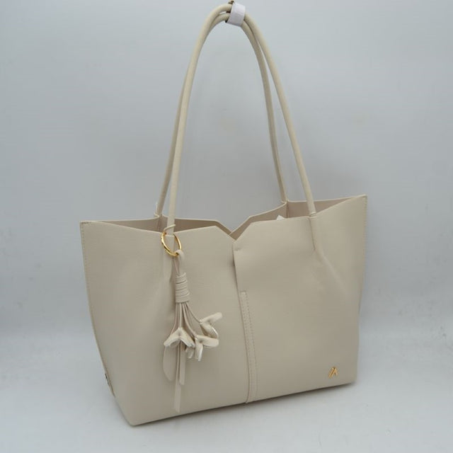 Beiige Bring a clean, contemporary aesthetic to your daily wardrobe with this sophisticated tote bag. Featuring a distinctive geometric cutout design along the upper trim, this shoulder bag offers a modern architectural edge while remaining perfectly functional. The smooth, textured exterior is detailed with subtle vertical center stitching and a small, polished metallic logo accent on the lower corner. Designed for comfort and convenience