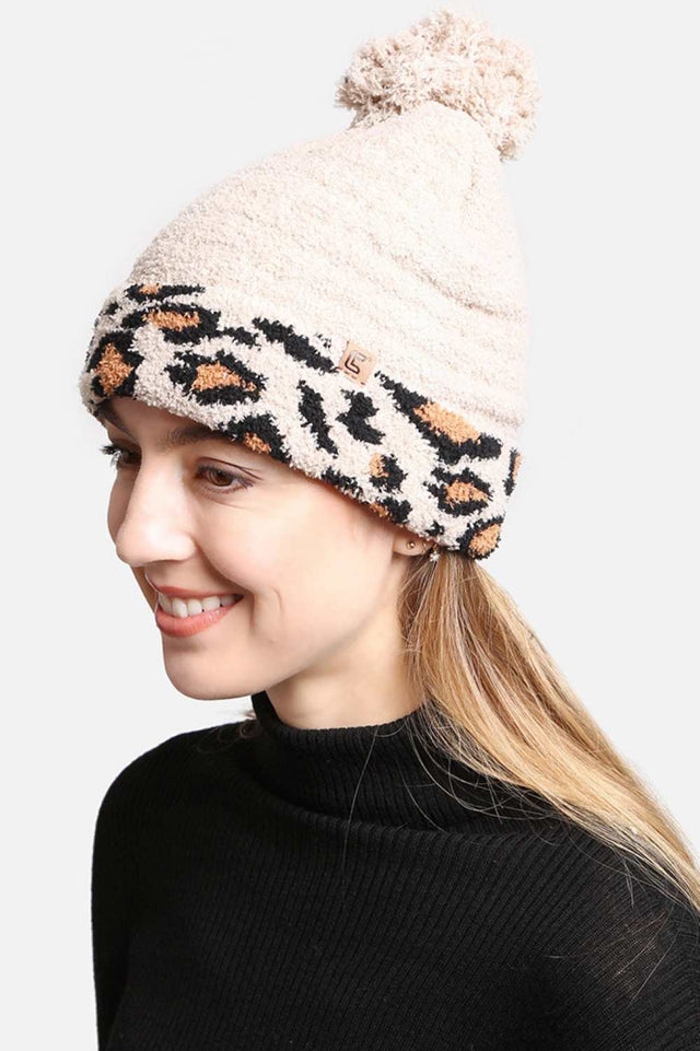 Beige The Leopard Cuffed Pom Pom Lining Beanie features a trendy animal print design with a stylish cuffed finish for a bold winter look. Crafted with a soft inner lining and topped with a fluffy pom pom, it delivers extra warmth, comfort, and a snug fit for chilly days.