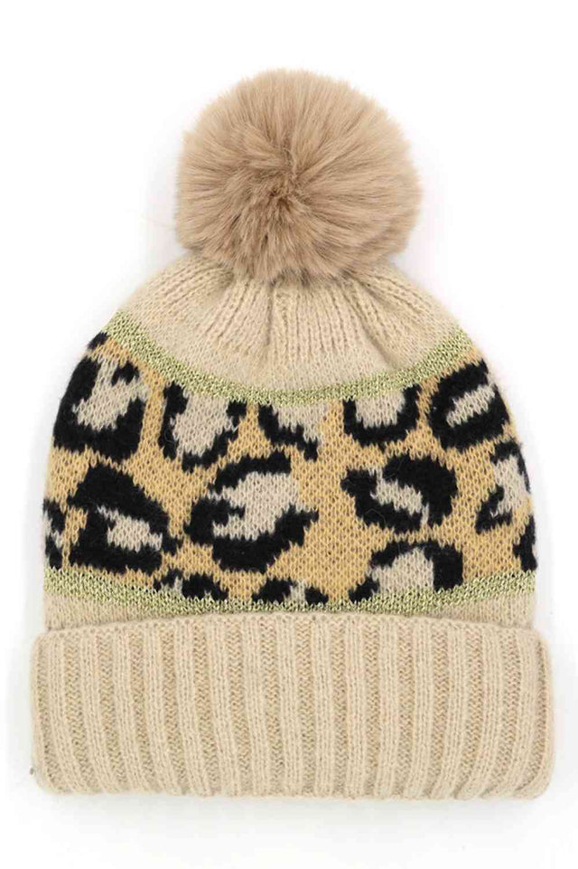 Beige Leopard PomPom Beanie features a bold leopard print design topped with a fluffy pompom for a trendy, winter-ready look. Made with a soft stretch fit, it delivers cozy warmth while adding stylish flair to your cold-weather outfits.