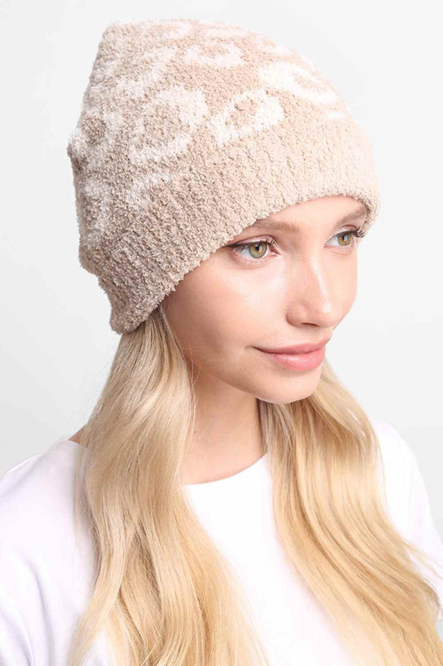 Beige Leopard Print with Ribbed Trim Beanie features a bold leopard print design accented with a ribbed trim for a stylish, trendy winter look. Made with a soft stretch fit, it provides cozy warmth while adding playful flair to your cold-weather outfits.