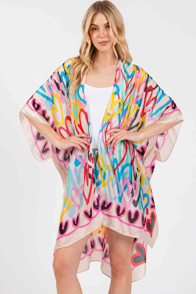 Beige Add a touch of romance to your summer collection with this multi-colored heart pattern kimono cover-up. Constructed from 100% polyester with a luxuriously silky feel, it's designed for comfort and style during warm months. The 35" x 36" dimensions offer generous coverage perfect for layering over swimwear or lightweight dresses. This versatile piece transitions seamlessly from beach days to casual evening wear, with a soft fabric that resists fading and maintains its silky texture through regular wear