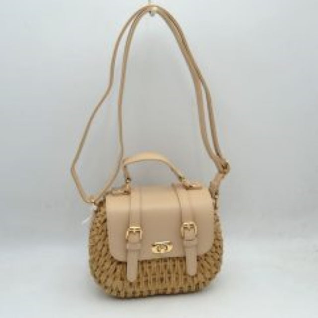 Beige This charming satchel features a woven straw body paired with a smooth faux leather foldover flap, making it a stylish choice for warm-weather outings. It is detailed with dual decorative buckle straps on the front along with a secure gold-tone turn-lock closure. Designed for versatile wear, it includes a sturdy top handle for handheld carrying and a long, adjustable shoulder strap for comfortable hands-free crossbody or shoulder styling.