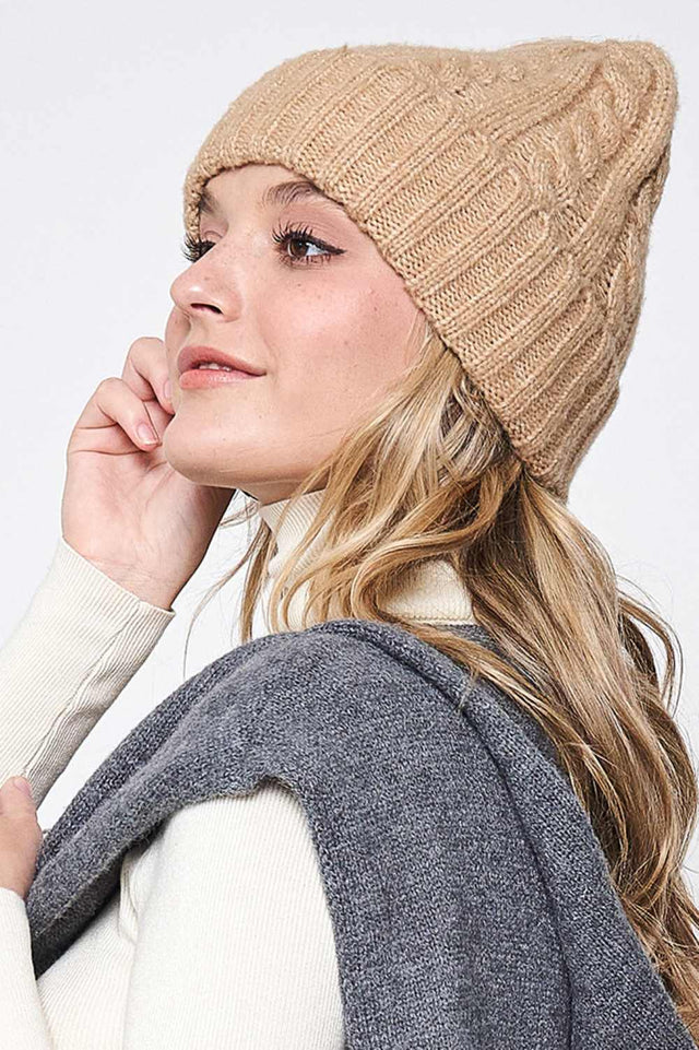 Beige Solid Cable Knit Beanie features a classic cable-knit texture in a clean, solid design for a timeless cold-weather look. Crafted with a soft stretch fit, it delivers cozy warmth and everyday comfort while effortlessly complementing any winter outfit.