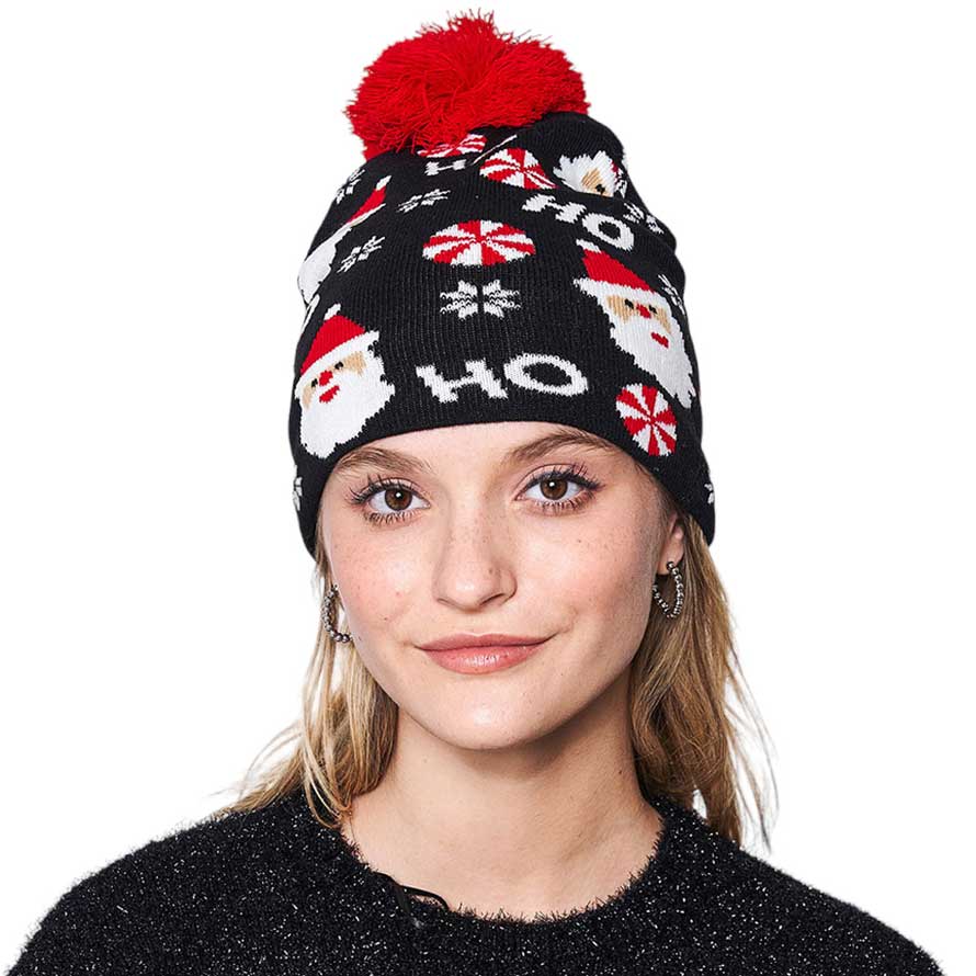 Black HoHoHo Message Santa Claus Candy Cane Pom Pom Beanie Hat. It's perfect for gifting to your loved ones on Christmas, or to treat yourself. Featuring an iconic message from Santa Claus himself, HoHoHo, this hat is perfect for spreading the cheer! It is an ideal winter accessory.