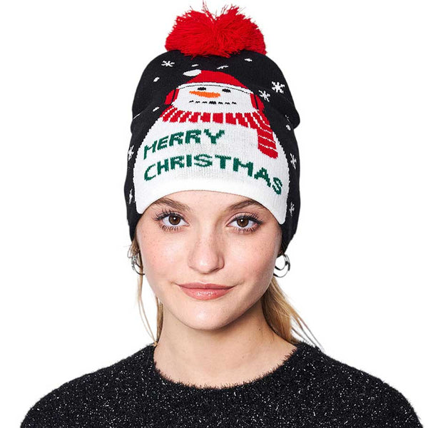 Black Merry Christmas Message Snowman Pom Pom Beanie Hat, is perfect for keeping you warm and festive during the winter season. It features a detailed embroidered snowman design stitched on the front, with the phrase “Merry Christmas” for a delightful holiday look. An ideal chilly gift to friends or family members.