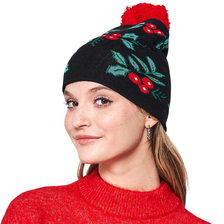 Black Mistletoe Pom Pom Beanie Hat. You'll love the classic look of the hat. Its cozy design combines style and comfort for a winter-ready look. Made with high-quality materials, this beanie is soft. Enjoy the festive look of the mistletoe pom pom, perfect for the winter season. Ideal gift item for any winter occasion.