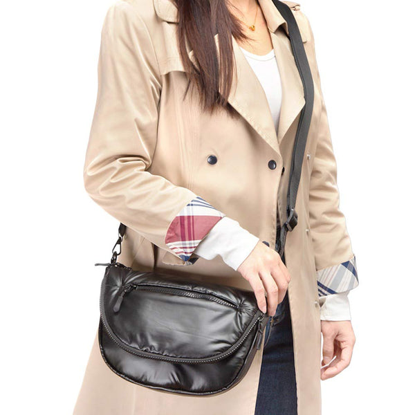 Black Puffer Half Moon Crossbody Bag, the lightweight, stylish design features a durable water-resistant nylon that is perfect for outdoor activities. The adjustable shoulder strap makes it easy to sling across your body for hands-free convenience. Carry your essentials in style and comfort with this fashionable bag.