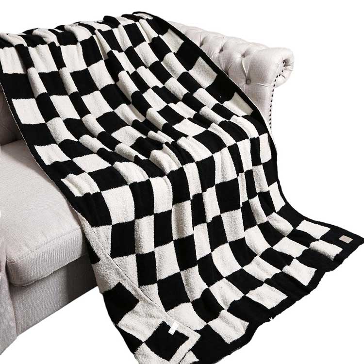 Black Reversible Checkerboard Patterned Throw Blanket, is perfect for adding a touch of style to any home. The reversible checkerboard pattern is eye-catching and timeless, making any living space look more inviting. Comfort and style in one cozy blanket! An ideal winter gift choice.
