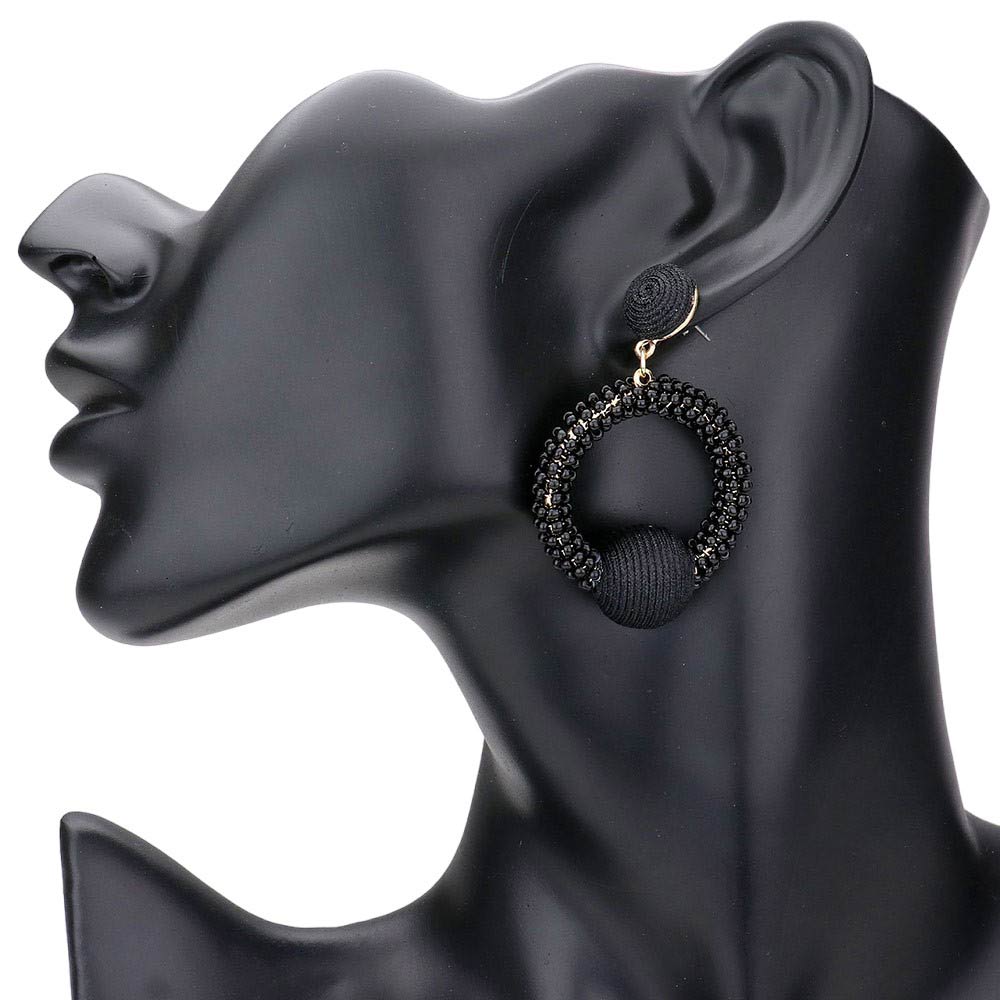 Black Thread Wrapped Ball Accented Seed Beaded Open Circle Dangle Earrings, Get in the loop with these playful earrings! The unique thread wrapped design and dangling open circles make for a quirky, fun addition to any outfit. Don't miss out on this trendy accessory (pun intended)!