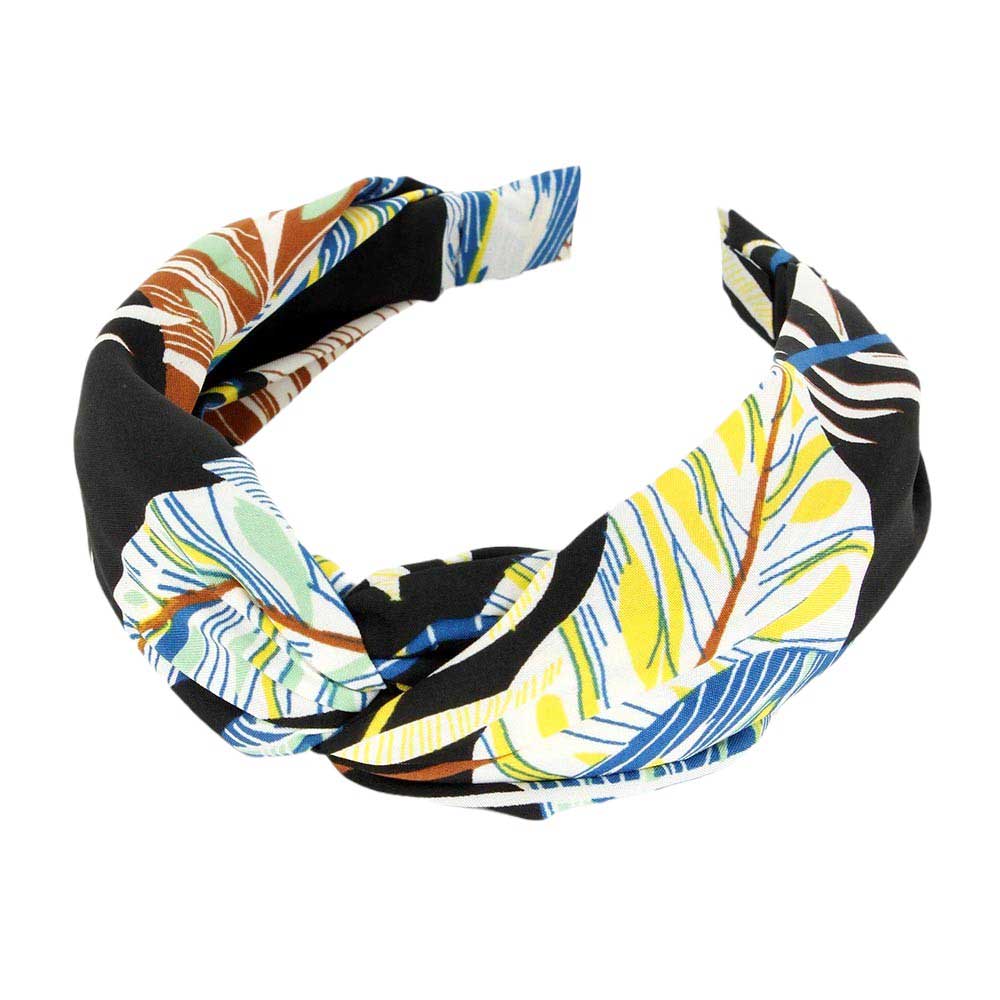 Black Tropical Leaf Patterned Twisted Headband, perfect for adding a touch of summer to any outfit. Crafted with a unique twisted design and featuring a vibrant tropical leaf pattern, this headband is both stylish and functional. Stay on-trend and keep your hair in place with this fashionable accessory.