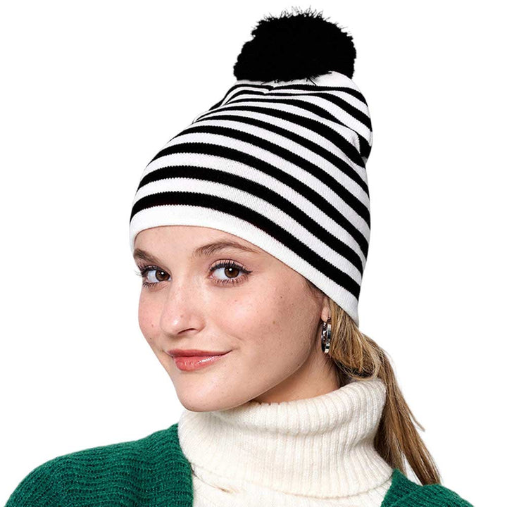 Black Two-Tone Striped Pom Pom Beanie Hat, is bound to keep you warm and fashionable. This sleek beanie is designed with striped, two-tone coloring for a timeless look, and topped with a playful pom pom for a touch of fun. Enjoy cold-weather coziness. Give this piece to your loved ones as a gift on the Christmas days.