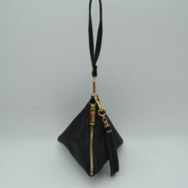 Black This unique handbag features a distinctive pyramid-shaped design that creates a geometric silhouette perfect for statement-making everyday use. The main storage compartment is accessed via a prominent, secure vertical zipper equipped with a large metallic pull tab. For easy carrying convenience, the bag is outfitted with a slender top wristlet loop and a matching hanging tassel accent attached securely to the top hardware hook, blending modern design with functional portability.