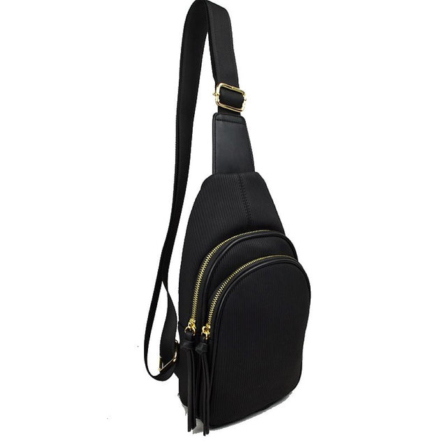 Black This practical sling bag features a textured, finely ribbed exterior w/ a tapered silhouette designed for comfortable everyday use. It offers organized storage compartments, including a curved main zippered section and a matching smaller front zippered pouch, both enhanced by elongated vertical tassel pulls hanging from the sliders. The bag is equipped w/ a single wide fabric shoulder strap attached to a smooth top panel & secured w/ a metallic adjustment buckle to easily customize the carrying length