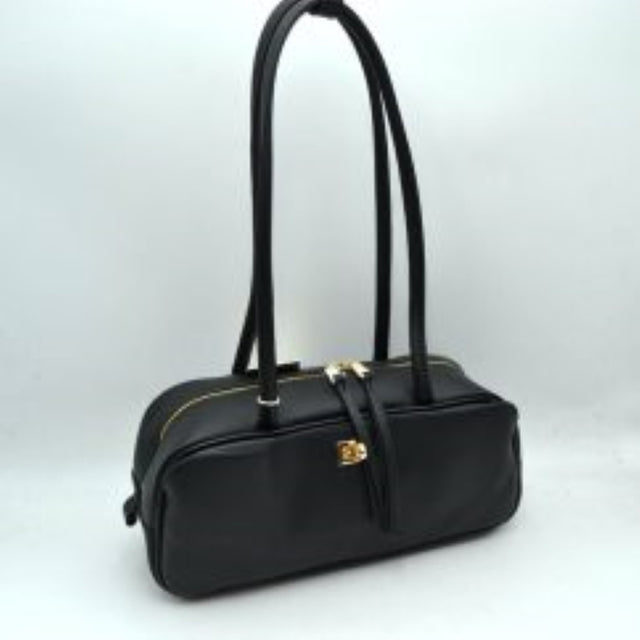 Black This structured shoulder bag features a smooth, elongated silhouette with a clean exterior finish, making it an excellent choice for modern everyday use. The design stands out with long, rounded double top straps that loop over the main body for comfortable carrying on the shoulder or by hand. It is equipped with a secure top zipper closure featuring dual long pulls