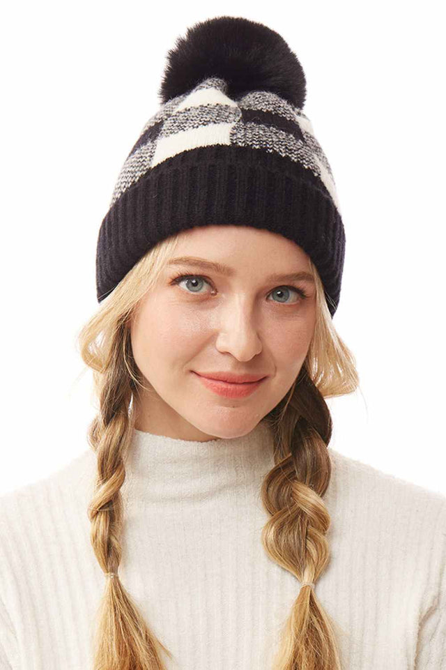 Black The Buffalo Check Beanie with Pom Pom features a classic plaid design that brings timeless style to your winter wardrobe. Made from soft, cozy knit fabric with a playful pom pom accent, it offers warmth, comfort, and a snug fit for chilly days.