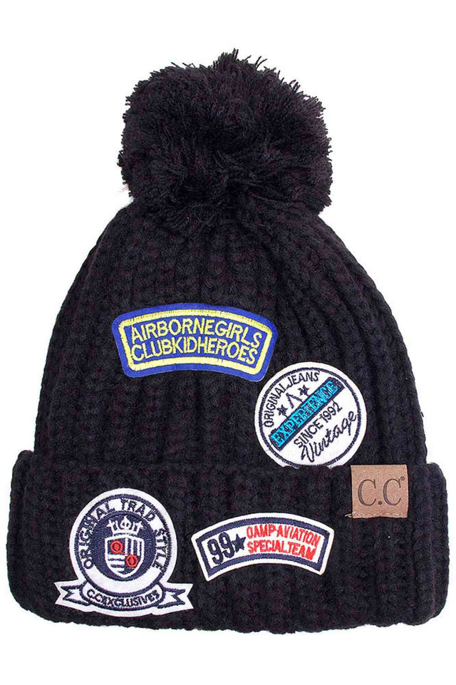 Black Stay warm in style with the C.C Fashion Pom Beanie With Patch. Crafted from 100% soft acrylic, this cozy beanie delivers exceptional comfort and durability for everyday wear. The signature pom pom adds a playful touch, while the decorative patch showcases timeless fashion appeal. One size fits most, making it the perfect accessory for anyone seeking quality and versatility. Whether you're heading outdoors or running errands, this beanie combines practicality with contemporary design.