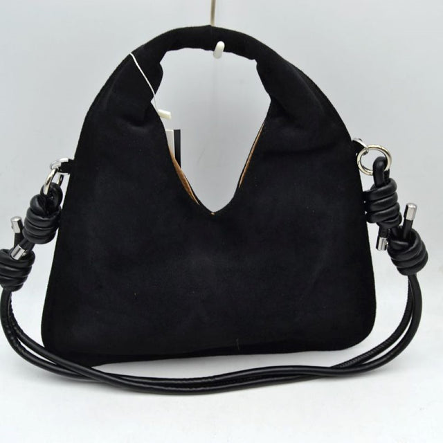 Black This slouchy hobo bag features a soft, matte suede-textured exterior with a modern silhouette, making it a stylish choice for everyday use. It is designed with a deep V-shaped cutout that transitions seamlessly into a comfortable, integrated top handle for an easy handheld carry. The look is elevated by a slender, matching shoulder strap attached to silver-tone side rings