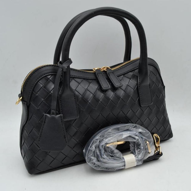 Black This structured satchel features an intricate woven exterior design with a classic dome silhouette, making it a sophisticated choice for elevated everyday use. It is detailed with sturdy, rounded dual top handles and a decorative hanging leather clochette charm for a touch of timeless style. A gold-tone double-zipper closure secures the main storage compartment, and the bag comes complete with a matching detachable long shoulder strap for versatile crossbody styling options.
