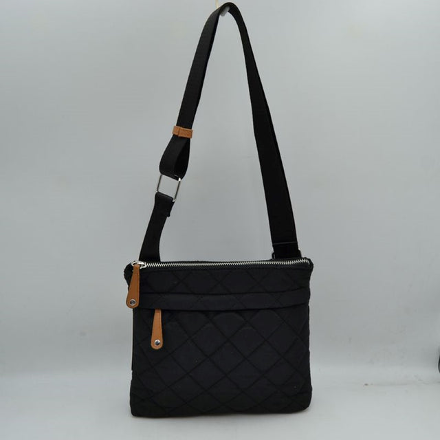 Black This functional messenger bag presents a classic diamond-quilted pattern across its main body, making it a reliable option for organized everyday use. It features a secure top zipper closure that opens to the primary storage compartment, complemented by a secondary horizontal zippered pocket on the front panel for quick-access items. Distinctive contrast tabs with metallic studs detail the zipper pulls