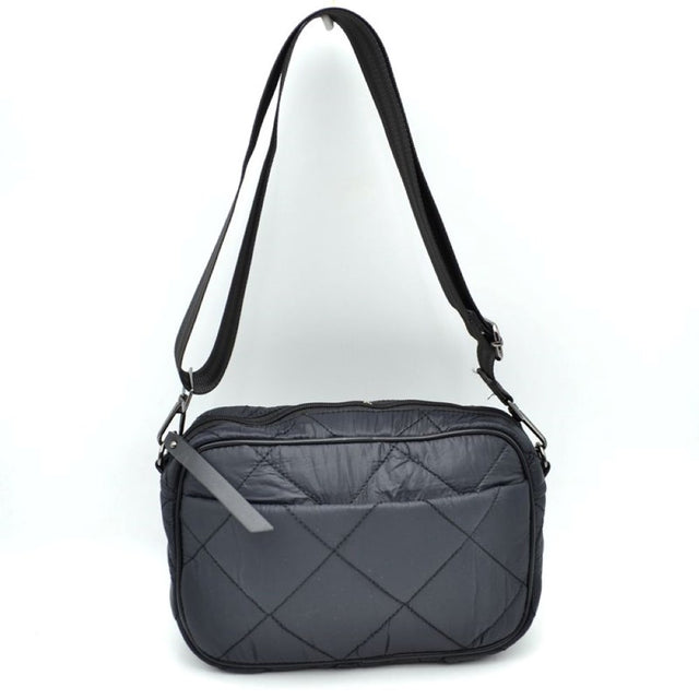 Black This functional crossbody bag features a soft, lightweight puffer exterior with a classic quilted diamond pattern in a sleek dark grey tone, making it a practical choice for organized daily use. The front panel is detailed with a subtle open slip pocket accented by a long, flat fabric pull on the corner. Equipped with a secure top zipper closure to keep your main compartment essentials safe, the bag is finished with gunmetal-tone hardware and a long, adjustable webbing shoulder strap for a comfortable
