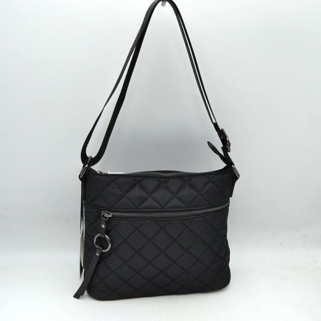 Black This functional crossbody bag features a classic quilted diamond pattern exterior designed for effortless everyday use. It offers multiple storage compartments, including a main interior section accessed by a top zipper closure and a horizontal front zippered pocket accented by an attached circular ring pull tab. The bag is equipped with a matching flat shoulder strap connected by side loops, featuring an integrated adjustment buckle to easily customize the carrying length.