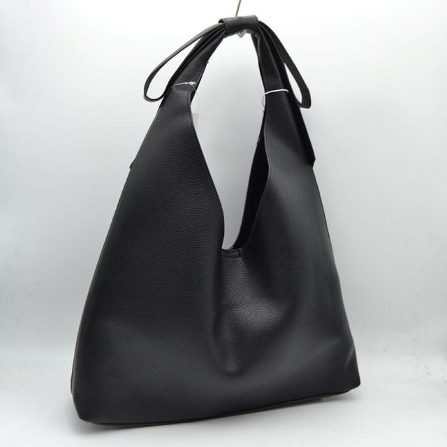 Black This everyday shoulder bag features a distinctive slouchy silhouette with a wide, integrated strap that is elegantly tied at the top. The spacious open-top main compartment offers effortless access to your daily essentials, while the clean design showcases a subtly textured exterior surface. Designed for comfortable over-the-shoulder wear, this versatile piece combines a modern aesthetic with practical, everyday functionality.