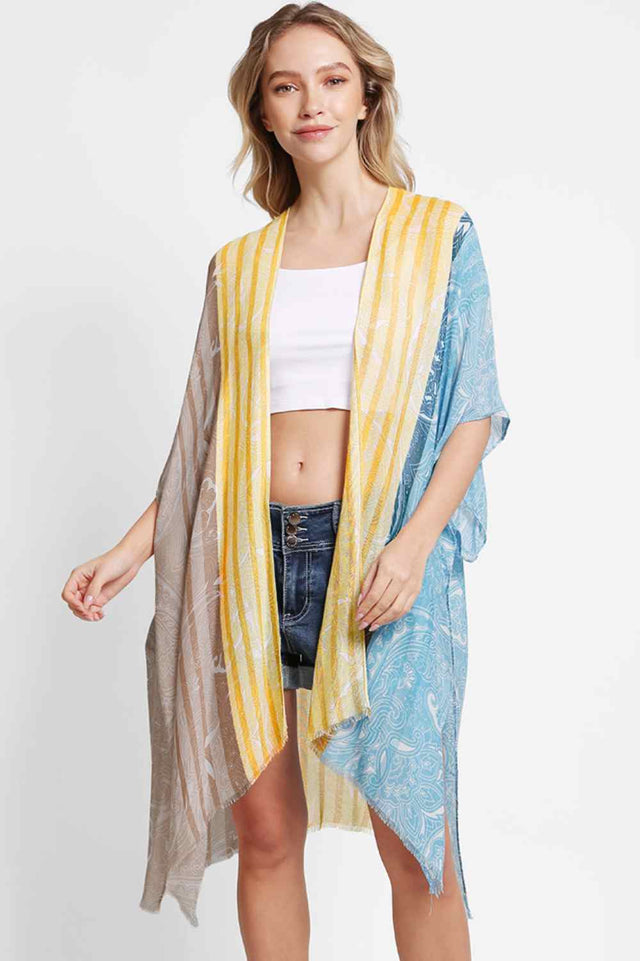 Black Effortless elegance meets summer style with this Paisley Pattern Stripe Kimono Cover Up. Crafted from 100% viscose, the lightweight fabric drapes beautifully while keeping you cool and comfortable. The intricate paisley and stripe design adds visual interest to any beach or resort look. Perfect for layering over swimwear or wearing as a standalone piece. Dimensions: 38" x 39". Made in China.