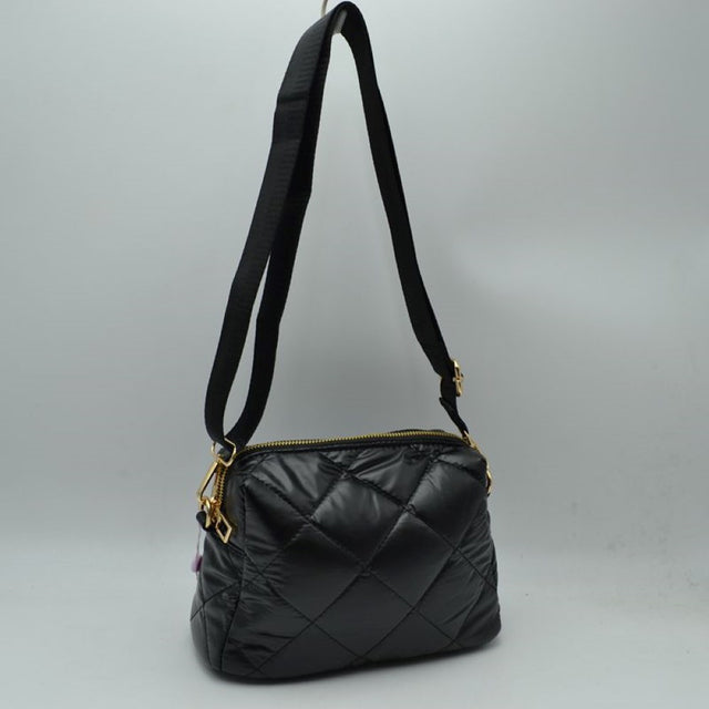 Black Upgrade your daily look with our Quilted Puffer Crossbody Bag. Blending street-style athleisure with everyday luxury, this handbag is engineered to keep your essentials organized without adding heavy bulk to your shoulders.