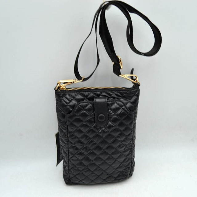 Black This functional vertical crossbody pouch bag is designed for organized everyday use, featuring a classic diamond-quilted exterior texture. The front panel includes a dedicated secondary storage compartment secured by a central vertical tab with a snap button closure for quick access to essentials. A secure top zipper opening keeping the main compartment safe is accented with polished metallic hardware