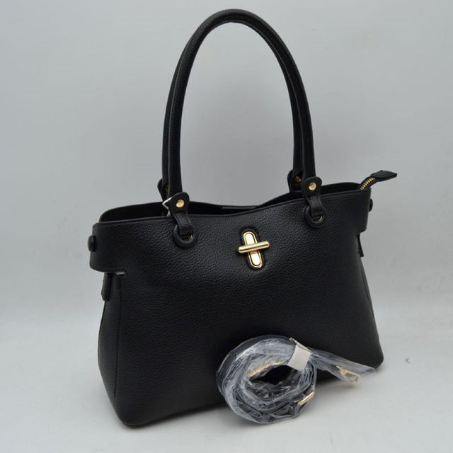 Black This everyday handbag features a structured silhouette with a distinctively textured exterior surface. Designed for versatile carrying options, it includes dual rounded top handles attached via metallic hardware studs alongside a separate, detachable shoulder strap. The front panel is accented with a prominent metallic turn-lock closure detail.