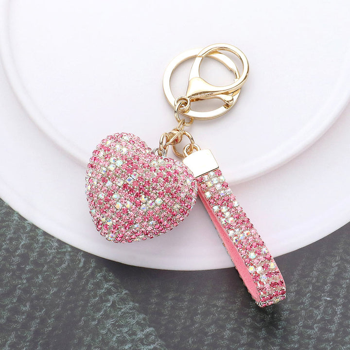 Bling Heart Keychain is a stylish accessory that adds a touch of elegance to your everyday look. Made with high-quality materials, it features a sparkling heart design that will catch everyone's eye. Perfect for keeping your keys organized and adding some glam to your day. 