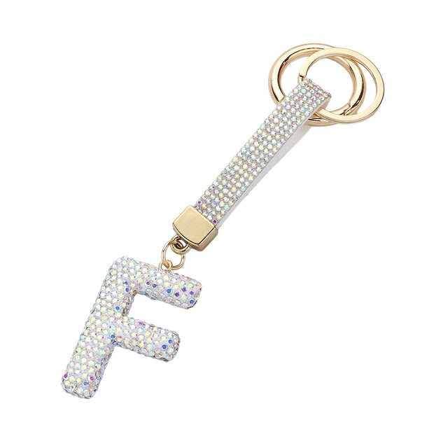 AB-Bling Studded Monogram Initial F Bag Charm adds a touch of elegance and personalization to any bag. Crafted with sparkling studs and featuring a monogram initial, this charm is the perfect accessory for the fashion-forward individual. Show off your unique style with this statement piece.
