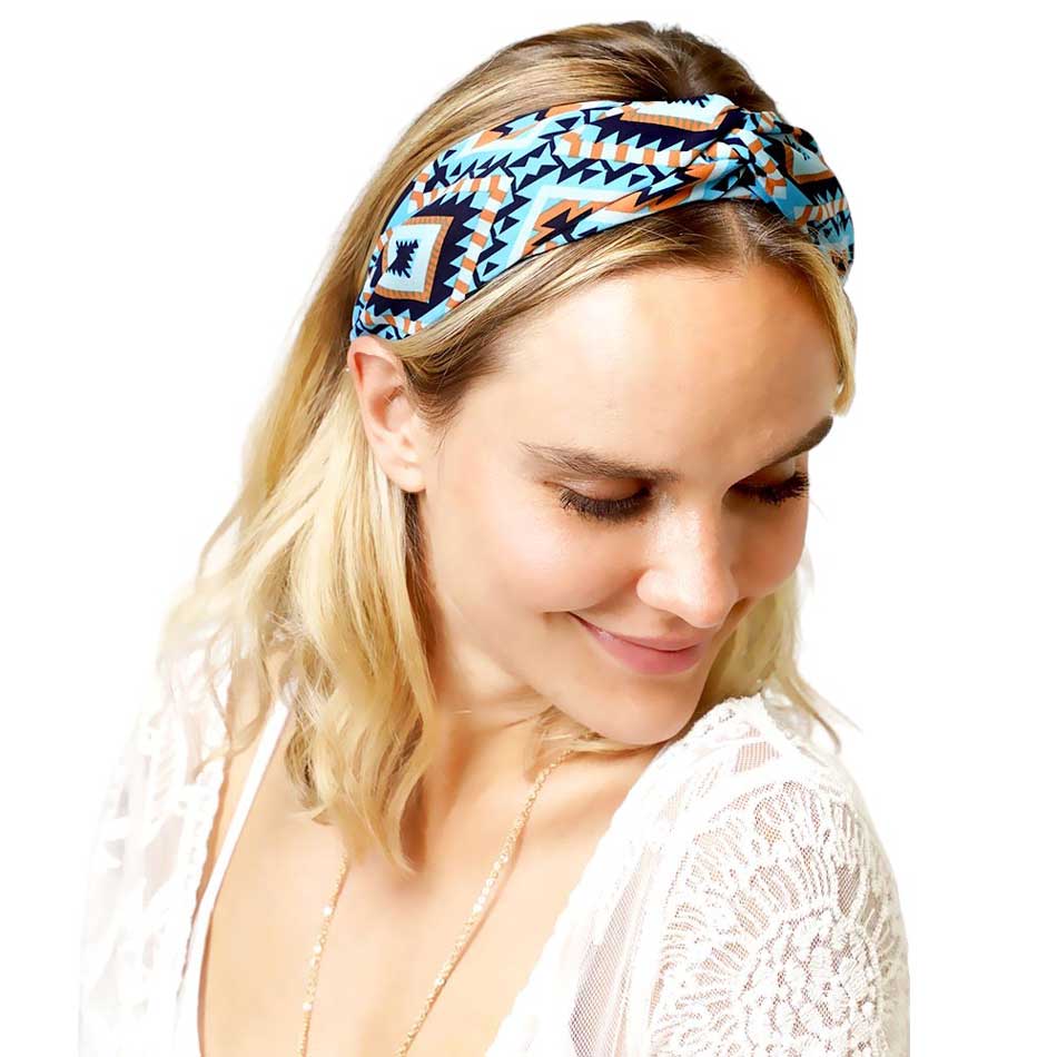 Blue Aztec patterned twisted headband is expertly designed to elevate your style while keeping your hair in place. Made with high-quality materials, it provides both functionality and fashion, giving you the best of both worlds. With its unique twisted design, this headband is perfect for any occasion.