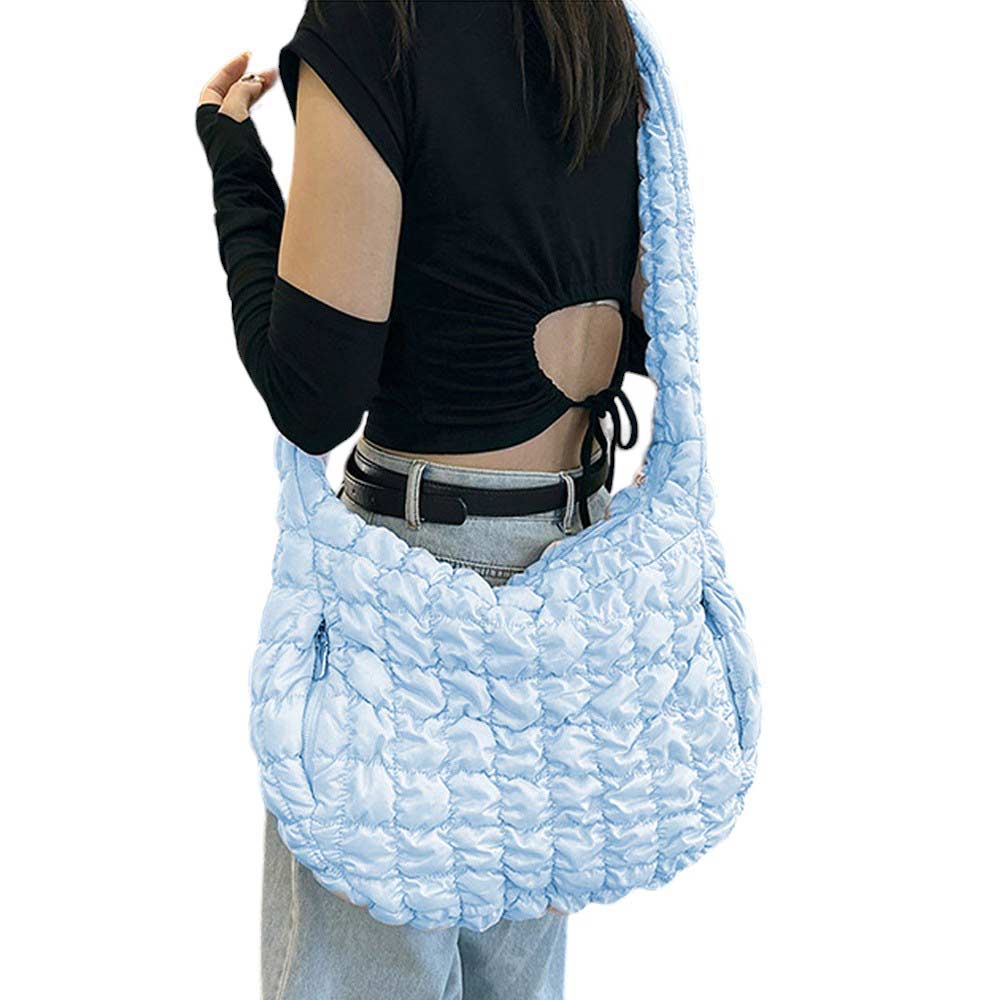 Blue Quilted Puffer Shoulder Crossbody Bag Cloud Bag, offers a sleek and stylish way to carry your essentials. Made with a unique quilted puffer design, this bag provides both durability and lightweight comfort. The perfect accessory for any occasion, it offers the perfect blend of fashion and function.