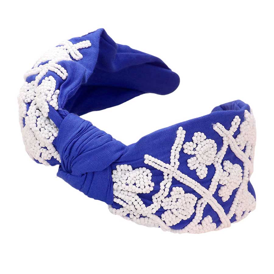 Blue White Be ready for game day with this stylish and comfortable Game Day Seed Beaded Paw Knot Burnout Headband. This headband is made from lightweight polyester and features a burnout design of paw knots with seed beads. Perfect for everyday wear, it's sure to make a statement and show your team spirit. 